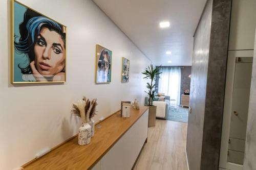 a hallway with a counter with a painting on the wall at be Unforgettable Apartment in Faro