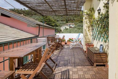 an outdoor patio with chairs and a roof at CREUZA DE 5 TERRE in Volastra