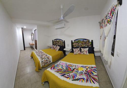 a room with two beds and a ceiling at Villas ponto in Holbox Island