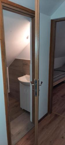 an open door to a room with a sink at Domek przy Złotym Groniu in Istebna