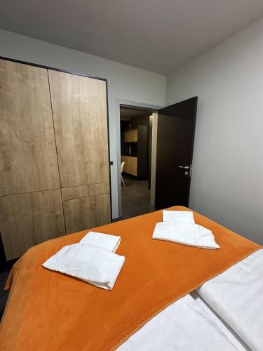 a bedroom with a bed with white towels on it at Boutique & Wellness Hotel Vital in Moravske Toplice