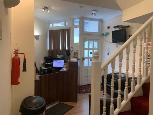 a living room with a staircase with a desk at City Lodge London in London