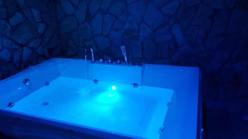 a blue bath tub with a candle in it at SPA Suite 21 in Augusta