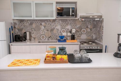 a kitchen with a counter with some food on it at Playas Art Hotel in Pinamar