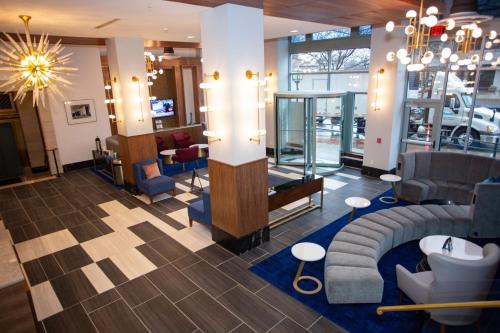 a lobby with chairs and a waiting room at BLU-Tique, Akron, a Tribute Portfolio Hotel in Akron