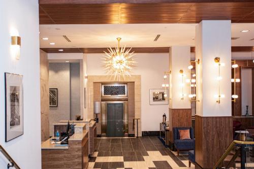 a lobby with a chandelier in a hotel at BLU-Tique, Akron, a Tribute Portfolio Hotel in Akron