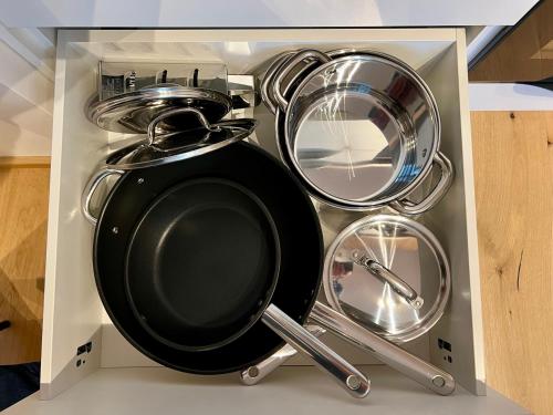 a bunch of pots and pans in a drawer at Golden Ridge Apartments in Špindlerův Mlýn
