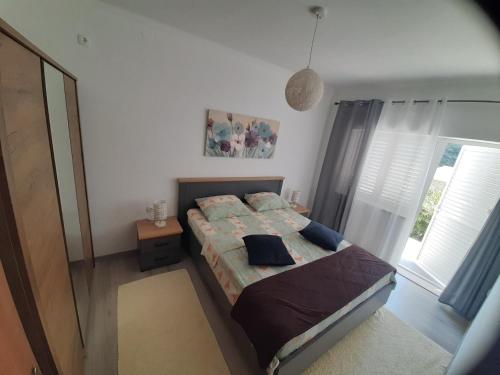 a bedroom with a bed and a large window at Franceska in Korčula