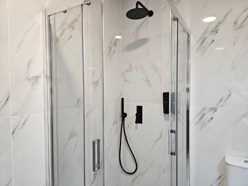 a shower with a glass door in a bathroom at Impero Nafplio Hotel & Suites in Nafplio