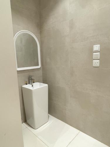 a bathroom with a toilet and a mirror at نزل الراشد الفاخرة luxury in Abha