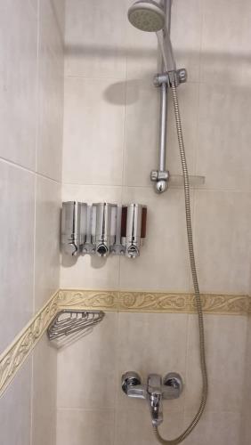 a shower in a bathroom with a shower head at Granada Apartments Elite Residence in Dubai