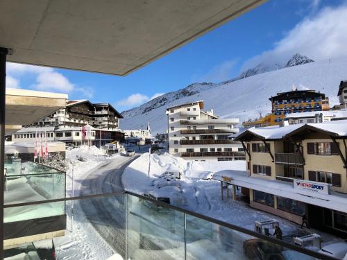 a view of a snowy mountain from a balcony at Kühtai Alpensuites in Kühtai