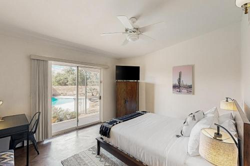 1 dormitorio con cama, escritorio y ventana en Sierra Vista, en Tucson