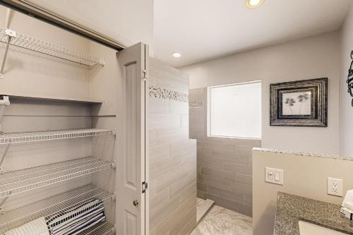 a bathroom with a walk in shower and a walk in closet at Sierra Vista in Tucson
