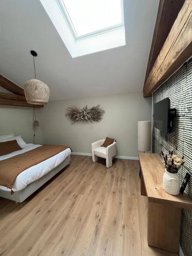 a bedroom with a bed and a skylight at Le Chai in Nissan-lez-Enserune