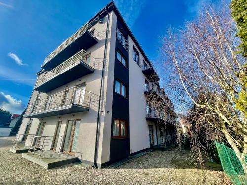 a black and white building with aventh floor at Baltic Sun SPA in Rewal