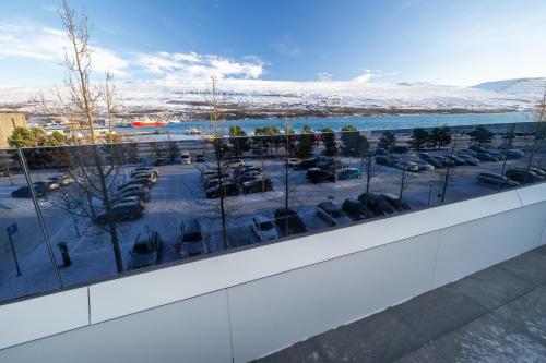 a view of a parking lot from the balcony of a building at Luxury stylish apartment central Akureyri in Akureyri