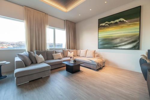 a living room with a couch and a table at Luxury stylish apartment central Akureyri in Akureyri