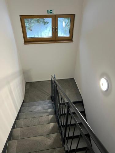 a staircase with a window in a building at Golden Ridge Apartments in Špindlerův Mlýn