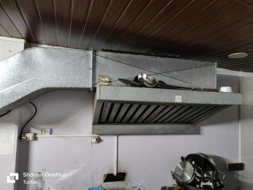 a kitchen with a metal counter top in a room at HOUSE 101 in Mumbai