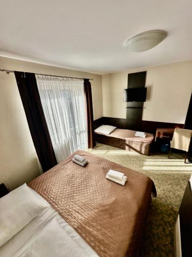 a hotel room with two beds in a room at Baltic Sun SPA in Rewal