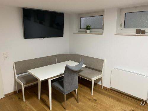 uma sala de jantar com mesa e cadeiras e uma televisão em Ferienstüble im Zabergäu- Ferienwohnung em Brackenheim