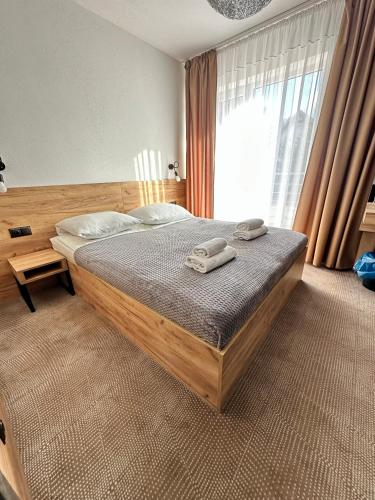 a bedroom with a bed with two towels on it at Baltic Sun SPA in Rewal