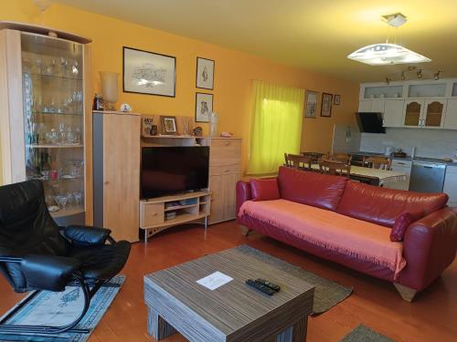 a living room with a red couch and a television at Park in Lazarevac