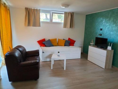 a living room with a couch and a chair at Casa Green in Silvi Marina