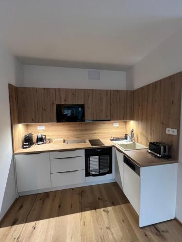 a kitchen with a sink and a counter top at Golden Ridge Apartments in Špindlerův Mlýn