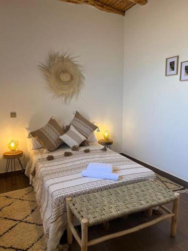 a bedroom with a large bed with pillows at Le petit Chalet. in Essaouira