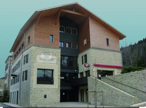 a large building with a brown roof at Restaurant Hôtel du Vercors in Saint-Martin-en-Vercors