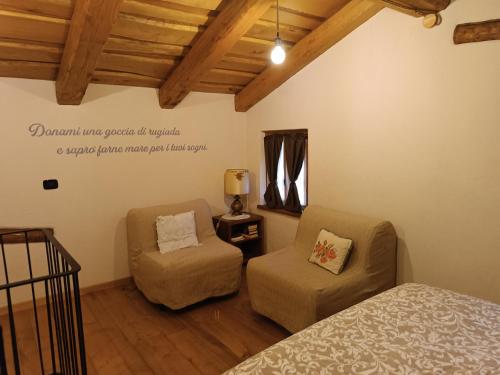 a bedroom with a bed and a chair at 'L ciabot 'd Ginota in Barge