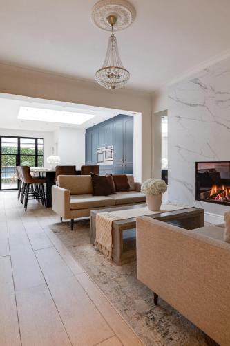 a living room with a couch and a fireplace at Luxury Georgian Townhouse with Cinema and parking in Chester