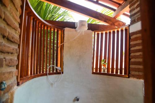 a bathroom with a bath tub with a window at Apartamento Floreal in Amontada