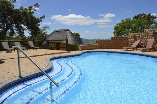 a swimming pool with a gazebo at White House Lodge in White River