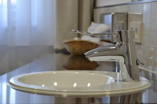 a bathroom sink with a faucet on a counter at Komforthotel Butjadinger Tor in Nordenham