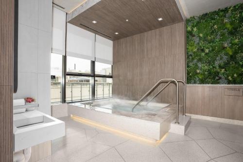 a bathroom with a bath tub with a large window at Level Chicago Fulton Market in Chicago