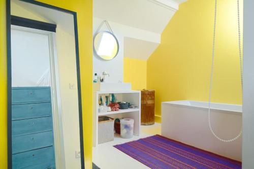 une salle de bain avec une baignoire et un miroir dans l'établissement Maison au Vallon des Auffes Marseille, à Marseille