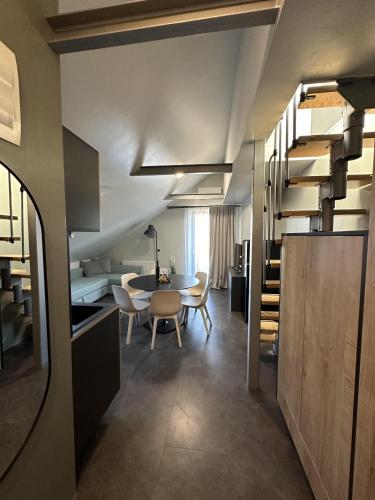 a kitchen and dining room with a table and chairs at Boutique & Wellness Hotel Vital in Moravske Toplice