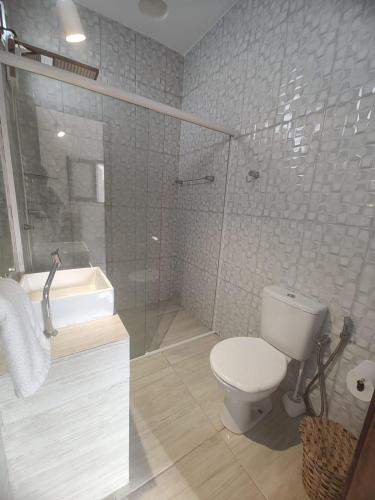 a bathroom with a toilet and a sink and a shower at Bons Aires in Atins