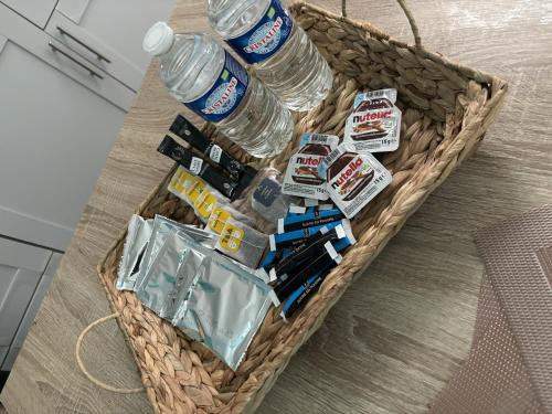 a basket with water bottles and other items in it at L'éclat balnéo in Malo-les-Bains