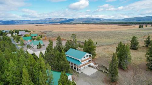 an aerial view of a house with a blue roof at Yellowstone Adventures in Island Park