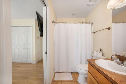 a bathroom with a shower and a toilet and a sink at Yellowstone Adventures in Island Park