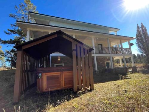 a house with a large wooden garage in front of it at Yellowstone Adventures in Island Park