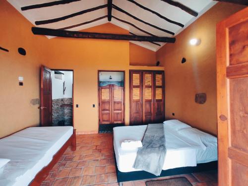 En eller flere senge i et værelse på Casa Hermosa Vista Barichara