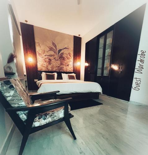 a bedroom with a bed and a bench in it at Elysium in Jaipur