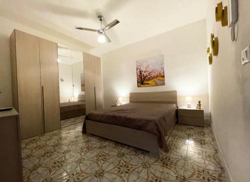 a bedroom with a bed and a bathroom at Igea Suite in Noto