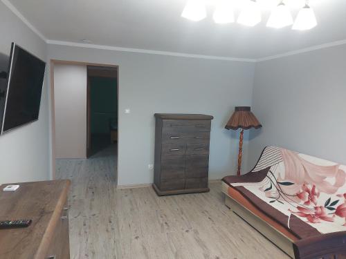 a living room with a desk and a dresser at DAR-KAJ MIESZKANIE nr 1 in Radzyń Chełmiński