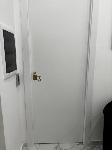 a white door with a television on top of it at Villa Life in San Donato Milanese